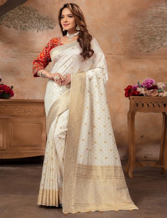 Cream dola silk saree with zari embellishment