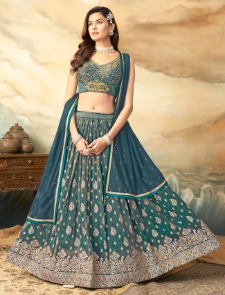 Green silk lehenga choli with intricate zari detailing