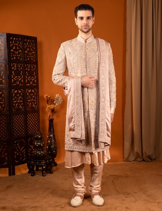 Cream silk wedding sherwani in rich work for groom