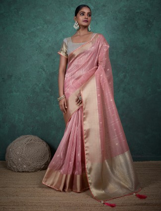 Graceful pink linen saree with woven zari accents