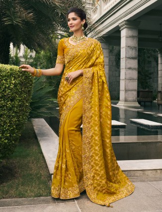 Vibrant mustard yellow saree in festive tissue silk