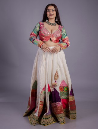 White silk lehenga with mirror and cowrie detailing