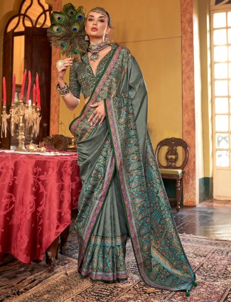 Vibrant green silk saree for celebrations with alluring print