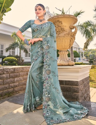 Sea green organza saree with ethnic detailing