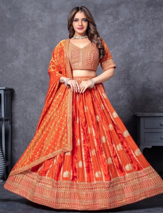 Vibrant orange silk ensemble with zari highlights