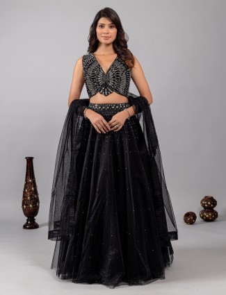 Black net lehenga choli with shimmering mirror accents