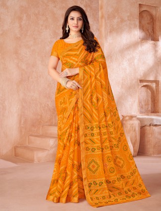 Orange chiffon saree featuring traditional bandhani print