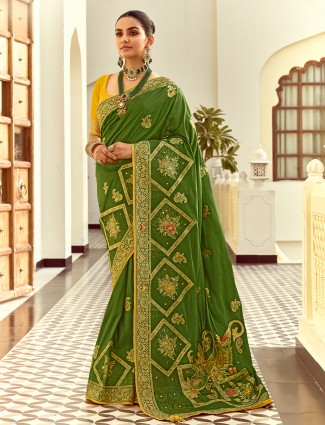 Green silk saree showcasing colorful motif weaving