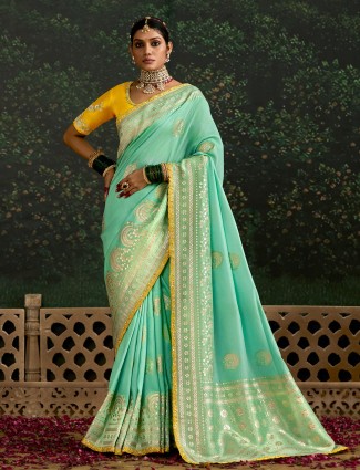 Mint green dola silk saree featuring zari weaving