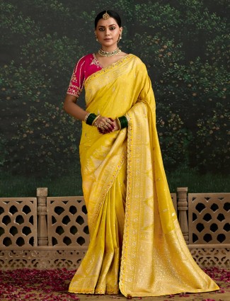 Yellow dola silk saree paired with bold blouse
