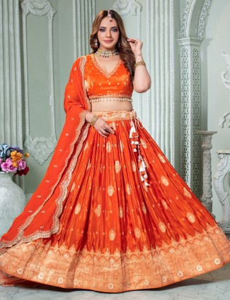 Radiant orange crepe silk lehenga choli for celebratory occasions