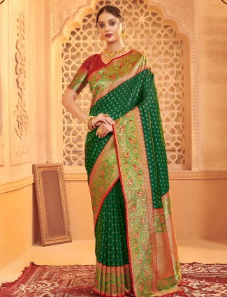 Green silk saree paired with a striking contrast red blouse