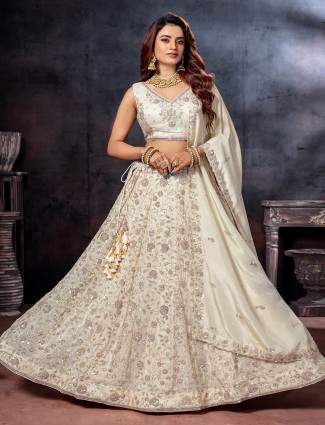 Off white sleeveless tissue silk lehenga choli
