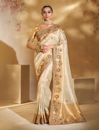 Cream silk festive saree highlighted with resham artistry