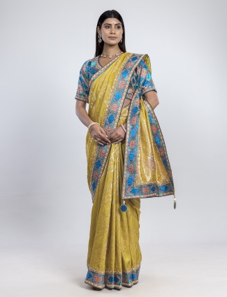 Sunlit yellow dola silk saree with blue readymade blouse