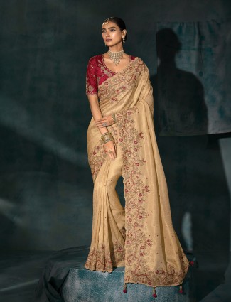 Cream silk saree paired with a striking maroon blouse