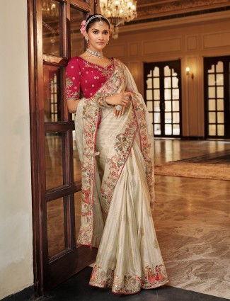 Off white festive silk saree paired with red blouse