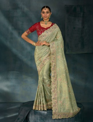 Pista green silk saree enhanced with shimmering resham artistry